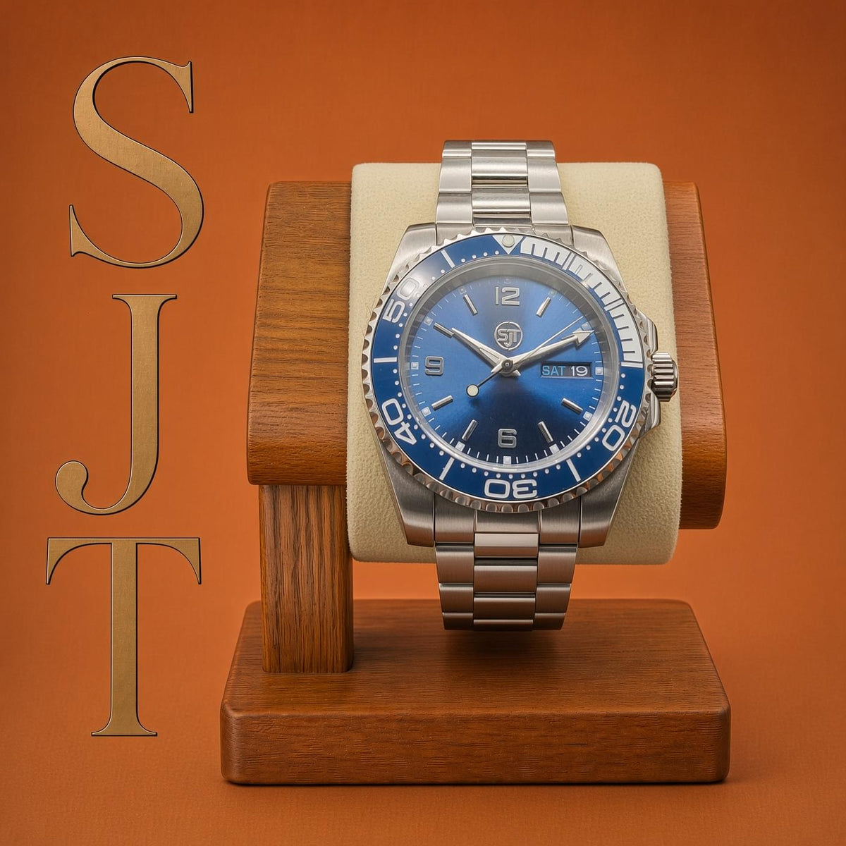 The Memo SJT Original wristwatch with a blue sunburst dial and blue bezel, displayed on a cream cushion mounted in a wooden stand against an orange background. Large gold letters 'SJT' appear on the left.