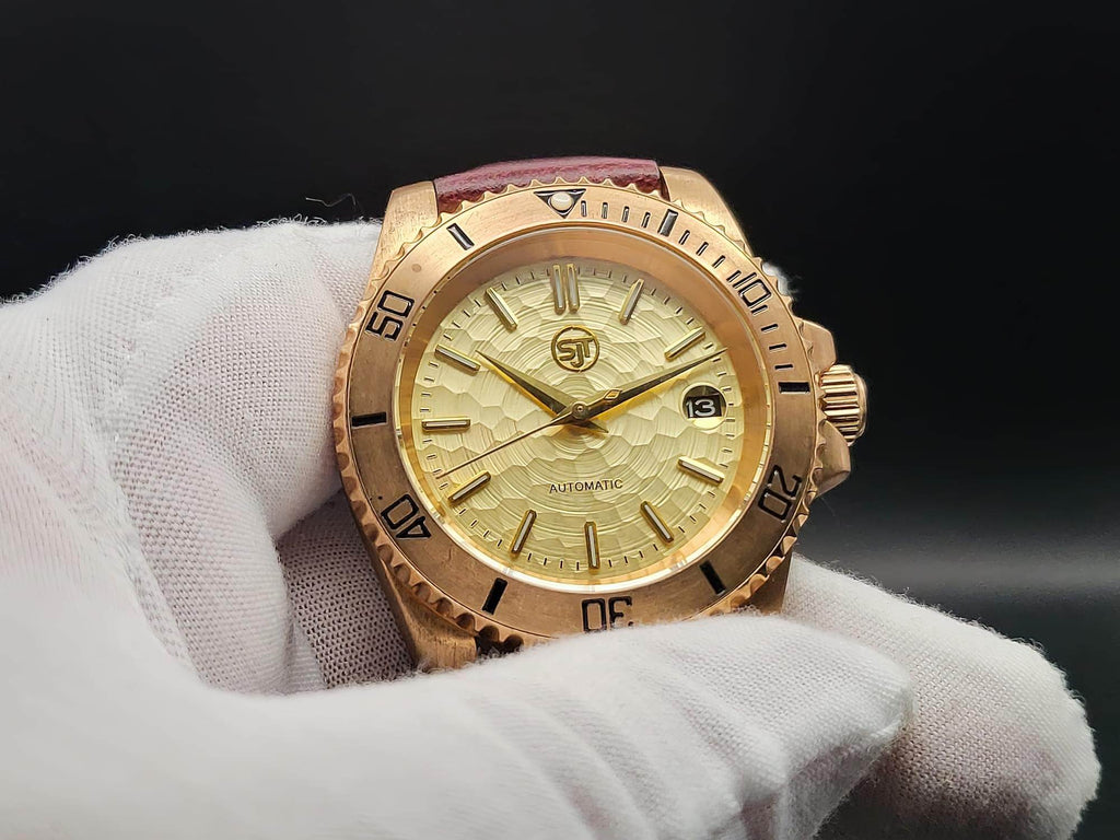 The Midas SJT Original wristwatch with a textured dial and bezel, held in a white-gloved hand against a dark background.