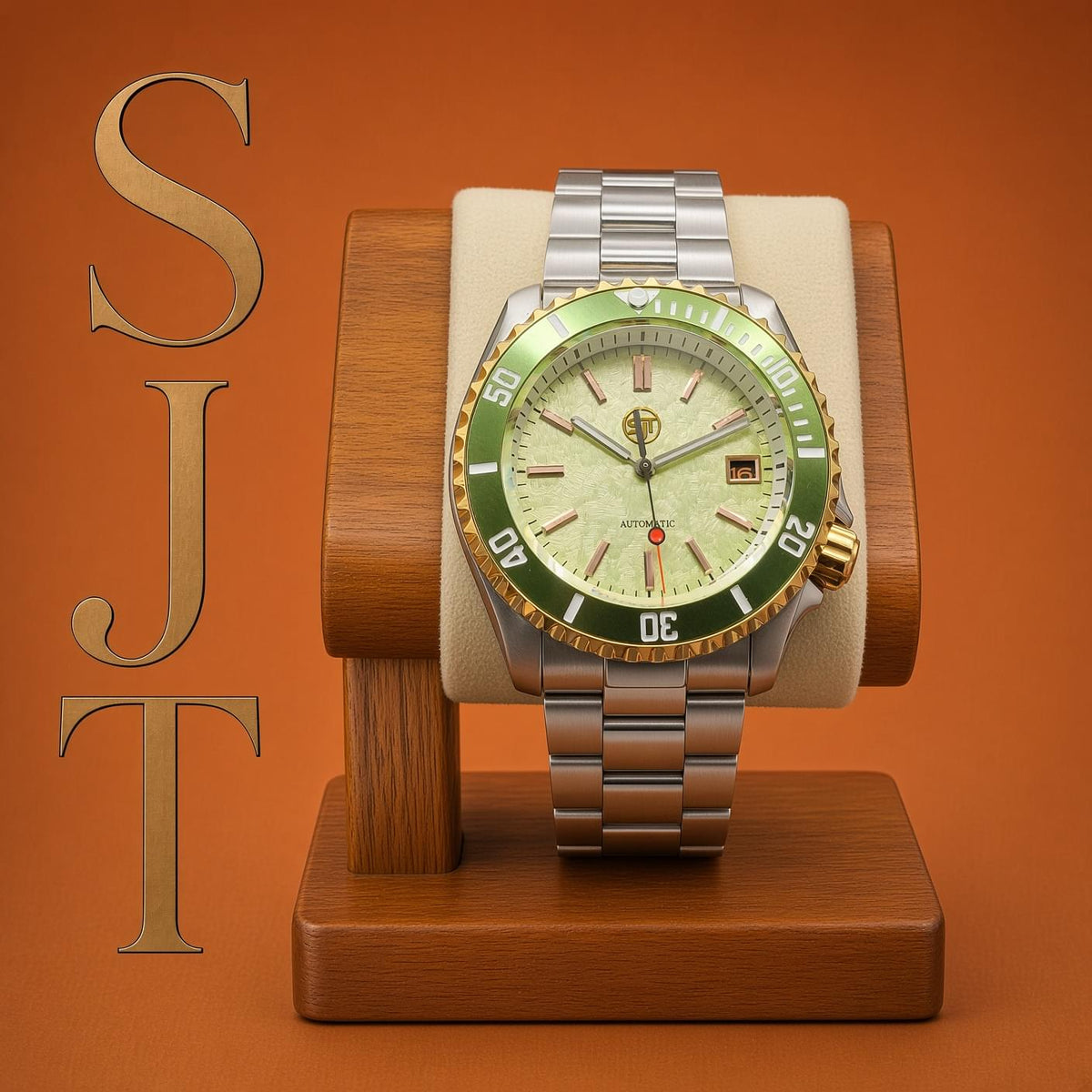 The Coconut SJT Original wristwatch with a green and gold bezel, cream dial, and silver-tone metal bracelet, displayed on a wooden watch stand against a warm orange background. The letters 'SJT' are vertically written on the left side.
